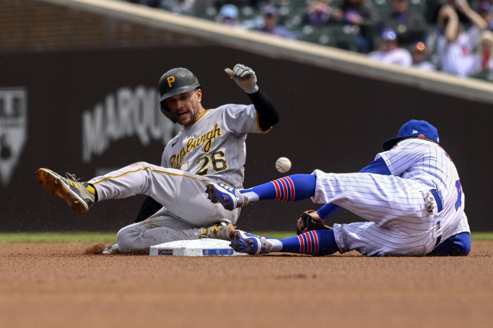 Pittsburgh Pirates Adam Frazier (26) slides safely into second base past Chicago Cubs infielder Eric Sogard (4) during the first inning of a baseball game, Saturday, May 8, 2021, in Chicago. (AP Photo/Matt Marton)