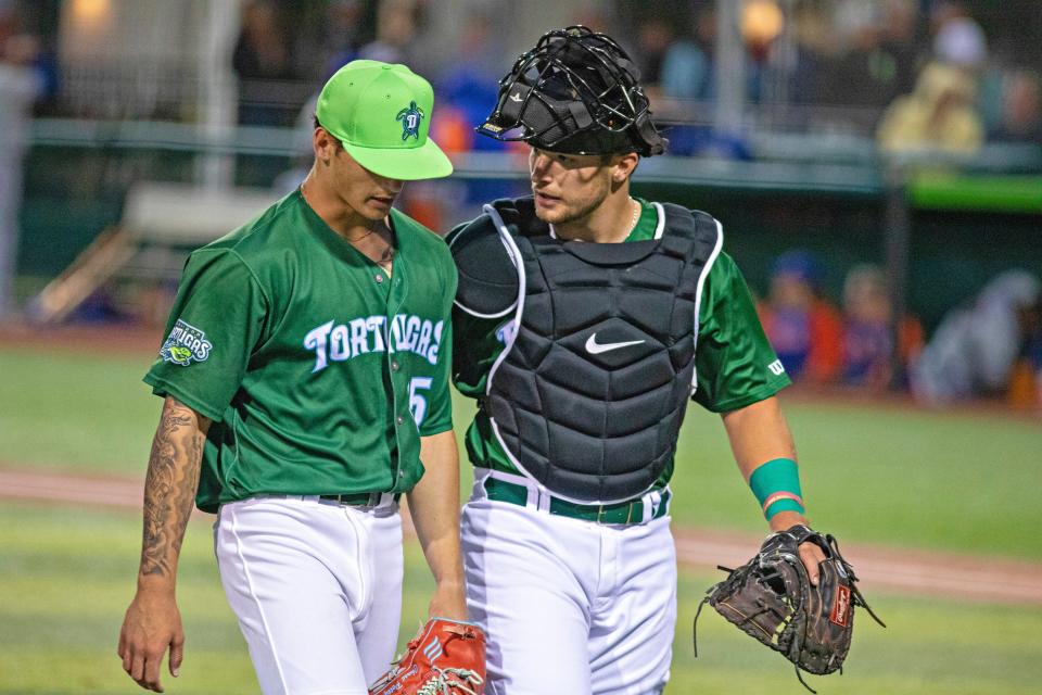 Hayden Jones, right, talks with Tortugas pitcher Chase Petty.