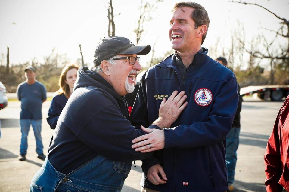 Danny Greene, of Bremen, Ky., jokes with Kentucky Gov. Andy Beshear as he examines damage at Church Street General Baptist Church in Bremen, Ky., Tuesday, Dec. 14, 2021. Greene is pastor of Church Street Church and rode out the storm by hiding in a spare room of the church with family members.