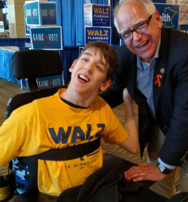 Vice presidential candidate and Minnesota Democratic Gov. Tim Walz (left) poses for a photo with writer and disability activist Justin Smith (right) at the DFL state convention in 2018.