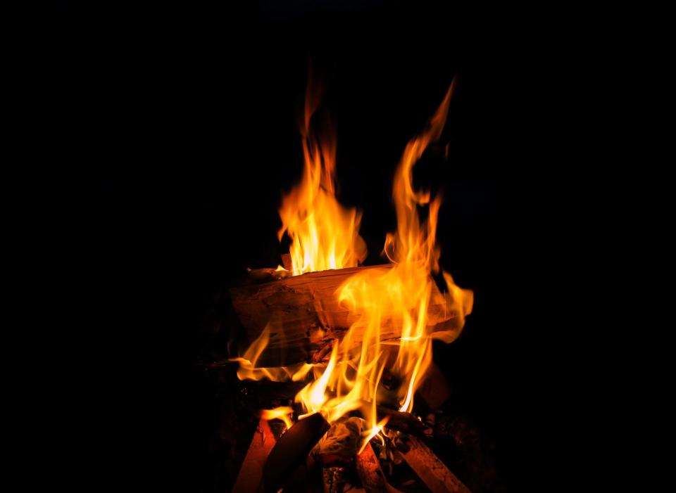 a photo of a log burning at night