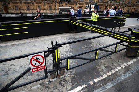 A police officer stands at the vehicle barrier to the Houses of Parliament where a car crashed after knocking down cyclists and pedestrians yesterday in Westminster, London, Britain, August 15, 2018. REUTERS/Hannah McKay