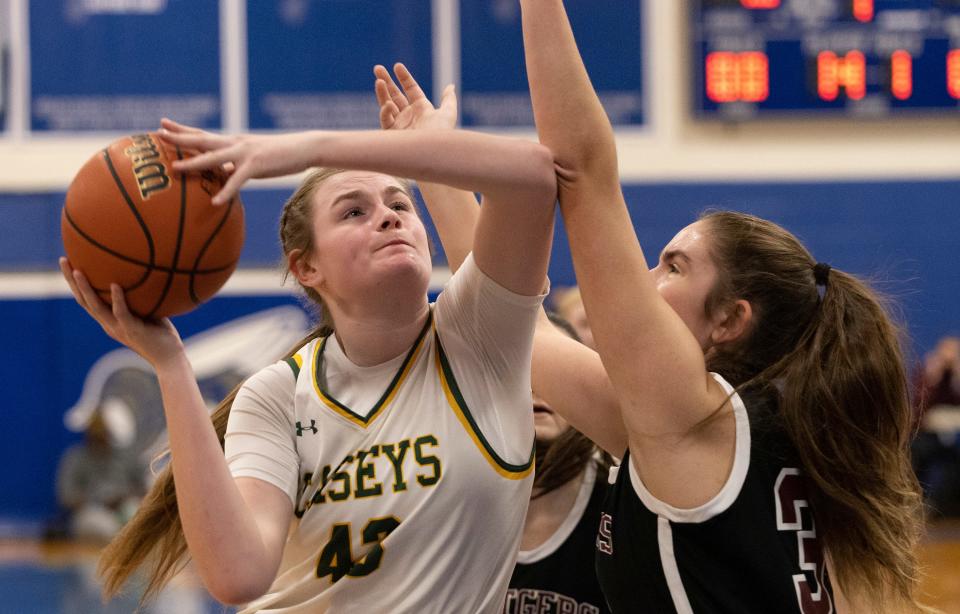 Red Bank Catholic Ally Carman goes up with a first half shot as Rutgers Prep Mackenzie Anderson tries to stop her. Red Bank Catholic Girls Basketball vs Rutgers Prep  in Coaches Choice Basketball Tournament at Holmdel on February 6, 2022. 