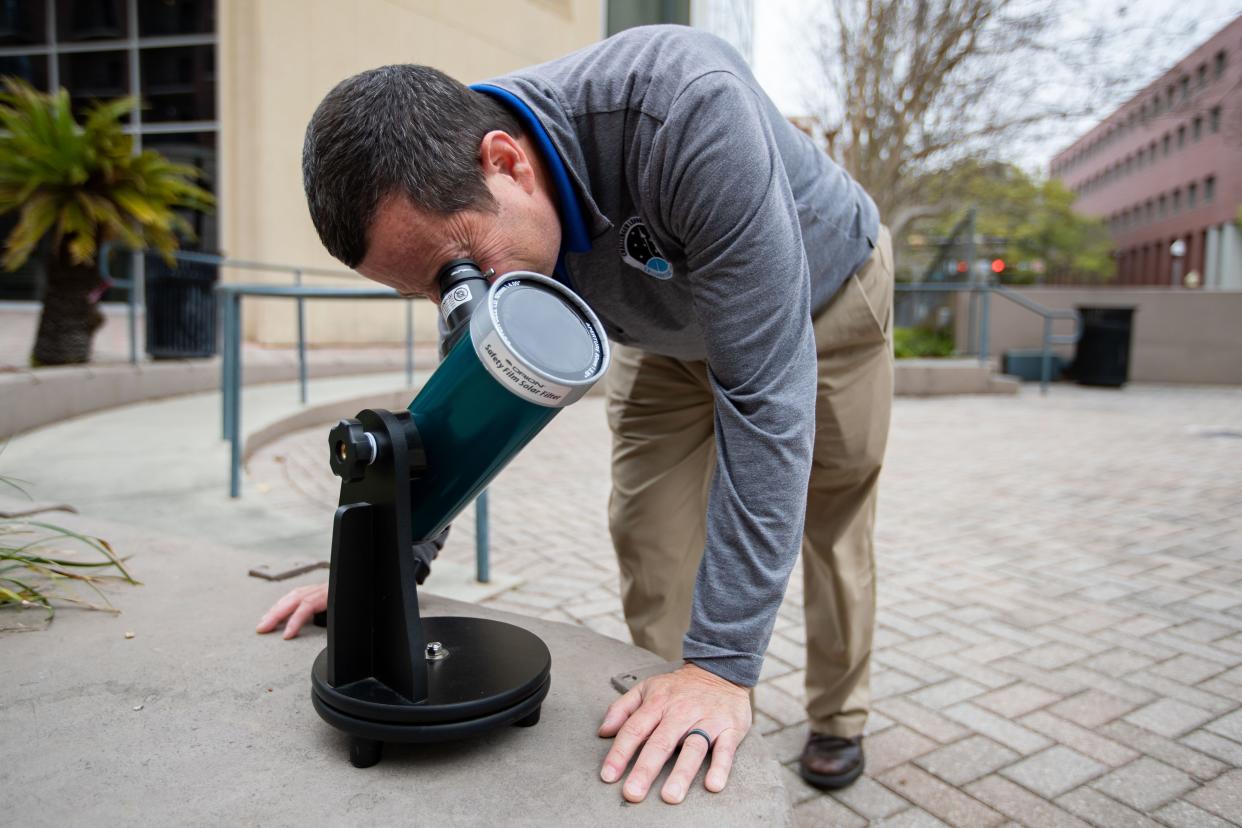 Alan Hanstein, executive director of the Challenger Learning Center, uses a special telescope to look directly at the sun Wednesday, March 13, 2024.