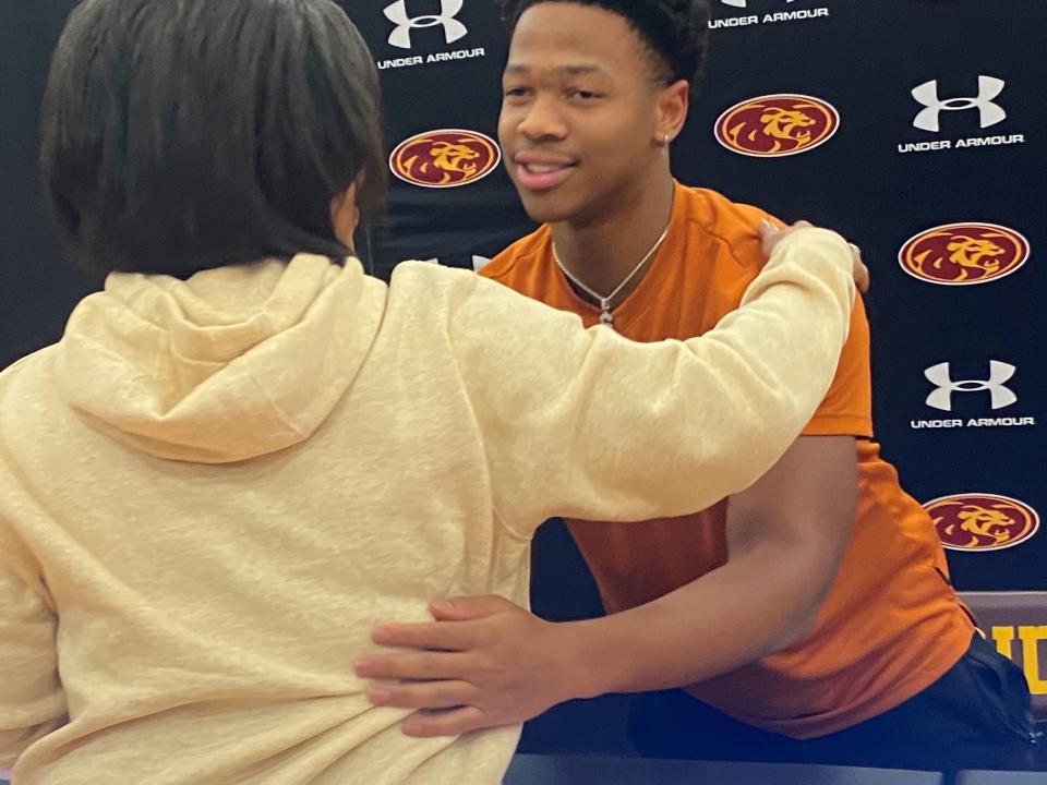 Phoenix Mountain Pointe running back Christian Clark hugs his mother after a ceremony at his school in which he signed with Texas. Clark rushed for 1,890 yards and 24 touchdowns in three varsity seasons.