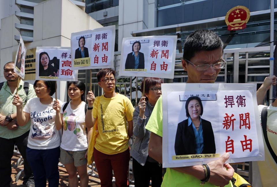 FILE - In this Friday, April 17, 2015 file photo, anti-Beijing protesters hold pictures of jailed veteran Chinese journalist Gao Yu during a rally outside Chinese central government's liaison office in Hong Kong. In a report by the Committee to Protect Journalists, the group said that after Turkey, the worst offender in 2016 was China, where 38 journalists were in custody on Dec. 1. China had jailed the most journalists worldwide in the previous two years. (AP Photo/Kin Cheung, File)