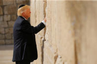 <p>U.S. President Donald Trump places a note in the stones of the Western Wall, Judaism’s holiest prayer site, in Jerusalem’s Old City on May 22, 2017. (Photo: Jonathan Ernst/Reuters) </p>