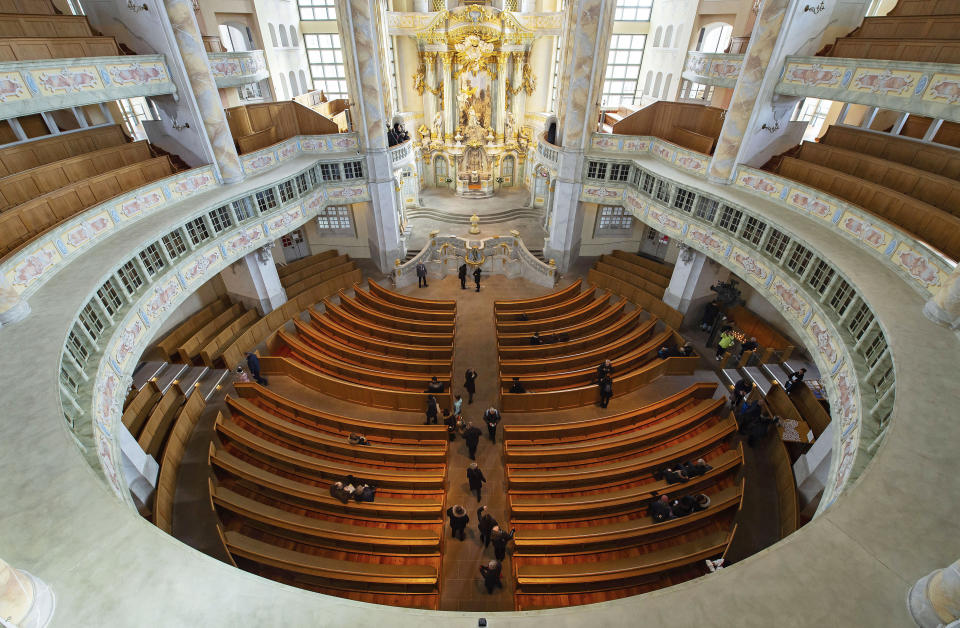 Visitors walk in the Frauenkirche cathedral (Church of Our Lady) in Dresden, Germany, Tuesday, Feb. 11, 2020 two days before the 75th anniversary of the Allied bombing of Dresden during WWII. British and U.S. bombers on Feb. 13-14, 1945 destroyed Dresden's centuries-old baroque city center. (AP Photo/Jens Meyer)