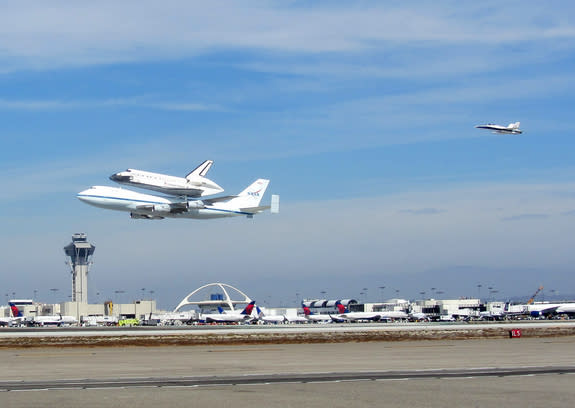 NASA's space shuttle Endeavour flies over Los Angeles International Airport while riding piggyback atop its Shuttle Carrier Aircraft on Sept. 21, 2012, during a4.5-hour aerial tour over California. The shuttle was being delivered to L.A., where