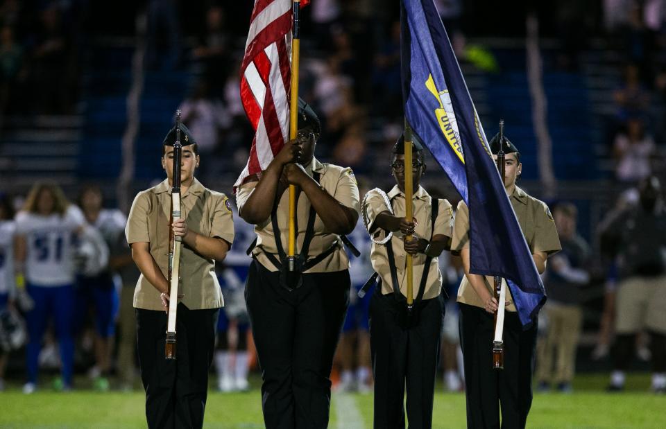 The Palm Beach Gardens JROTC Color Guard displays flags prior to the start of a football game. JROTC is a choice program at 14 high schools in Palm Beach County.