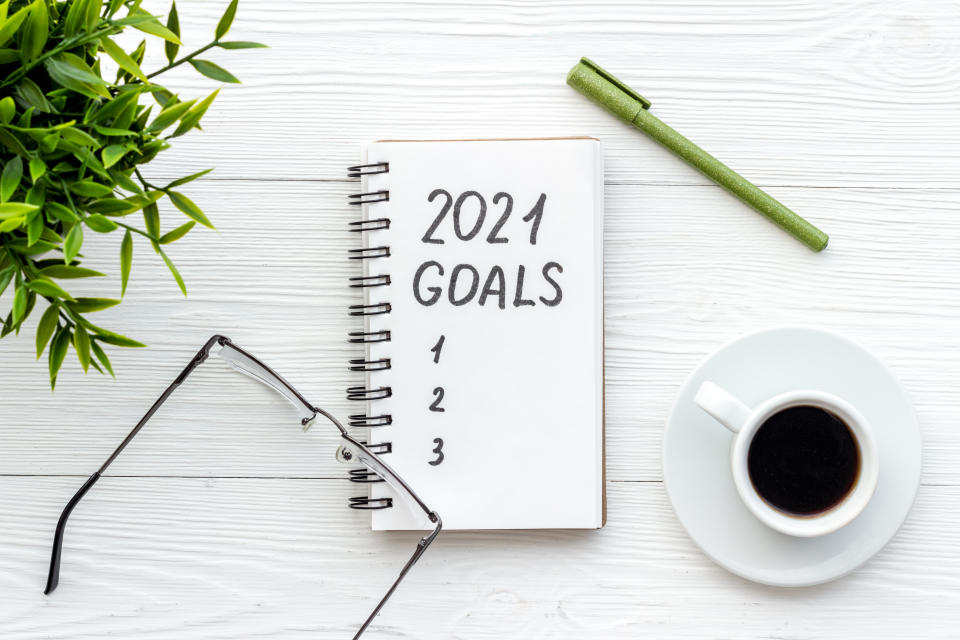  New Years goals written in notebook on a table.