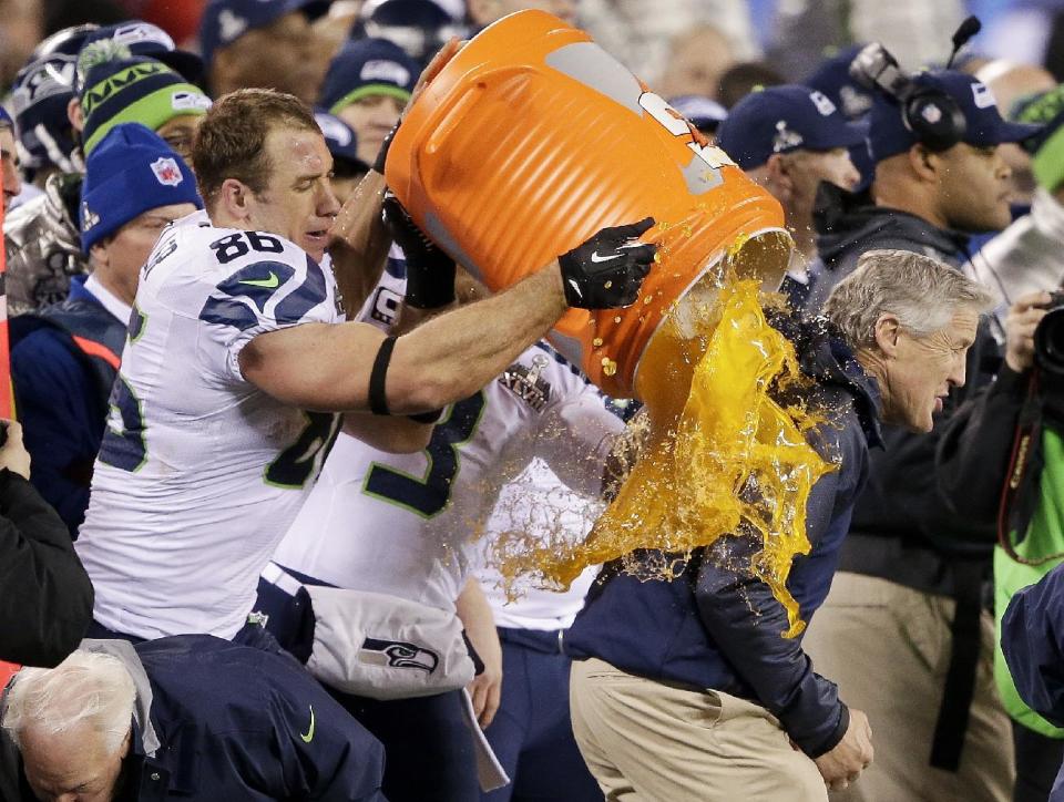 Seattle Seahawks' Zach Miller dumps Gatorade on Seattle Seahawks head coach Pete Carroll during the second half of the NFL Super Bowl XLVIII football game Sunday, Feb. 2, 2014, in East Rutherford, N.J. The Seahawks won 43-8. (AP Photo/Gregory Bull)