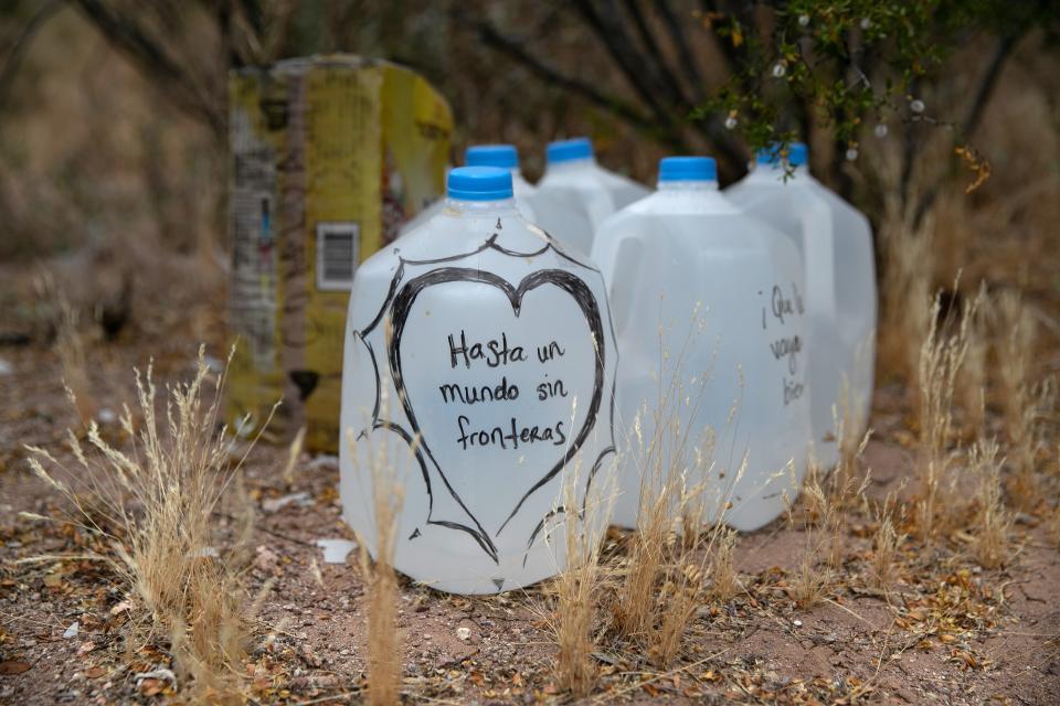 Jugs of water for undocumented immigrants sit along migrant trails after being delivered by the humanitarian aid group No More Deaths near Ajo, Ariz. Volunteers for the group distribute the aid in remote areas immigrants pass through after crossing the border from Mexico.