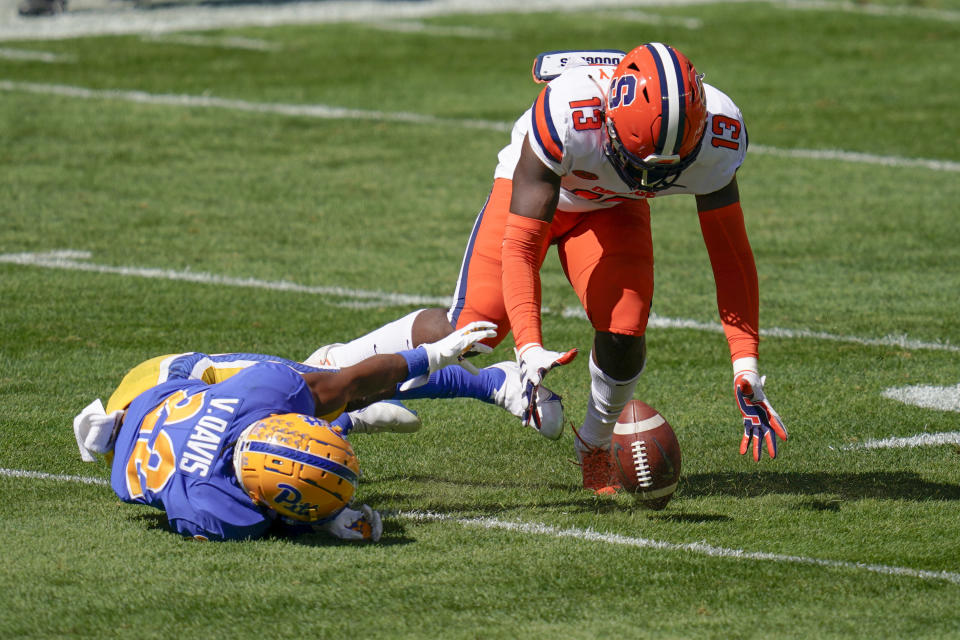 Syracuse linebacker Mikel Jones (13) recovers the ball after Pittsburgh running back Vincent Davis (22) missed a backward pass during the first half of an NCAA college football game, Saturday, Sept. 19, 2020, in Pittsburgh. Syracuse recovered. (AP Photo/Keith Srakocic)