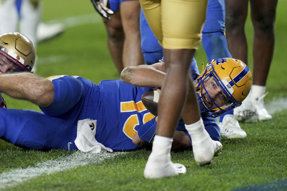 Pittsburgh quarterback Nate Yarnell (19) scores a touchdown against Boston College during the first half of an NCAA college football game Thursday, Nov. 16, 2023, in Pittsburgh. (AP Photo/Matt Freed)