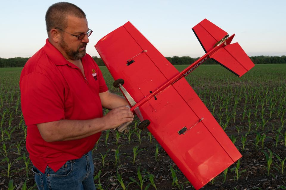 After an off-field landing in a cornfield, Patrick Deuser inspects his SIG Fazer rc aircraft May 15 after an inverted flight caused the engine to quit. "Normally you like to land on the runway," Deuser said.