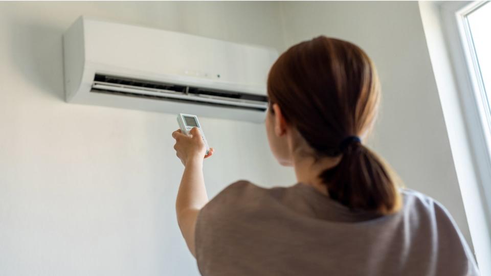 Woman turning on heater