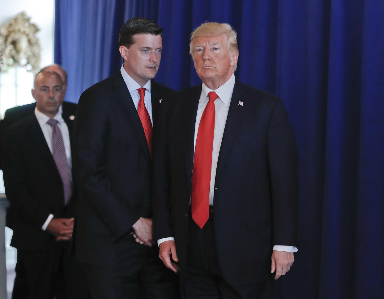 Rob Porter, left, White House Staff Secretary speaks to President Donald Trump after Trump made remarks regarding the on going situation in Charlottesville, Va., Aug. 12, 2017 at Trump National Golf Club in Bedminister, N.J.  (Photo: Pablo Martinez Monsivais/AP)