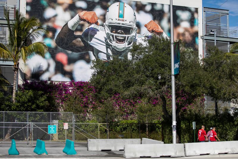 People walk next to Hard Rock Stadium prior to Super Bowl LIV between the San Francisco 49ers and the Kansas City Chiefs in Miami Gardens