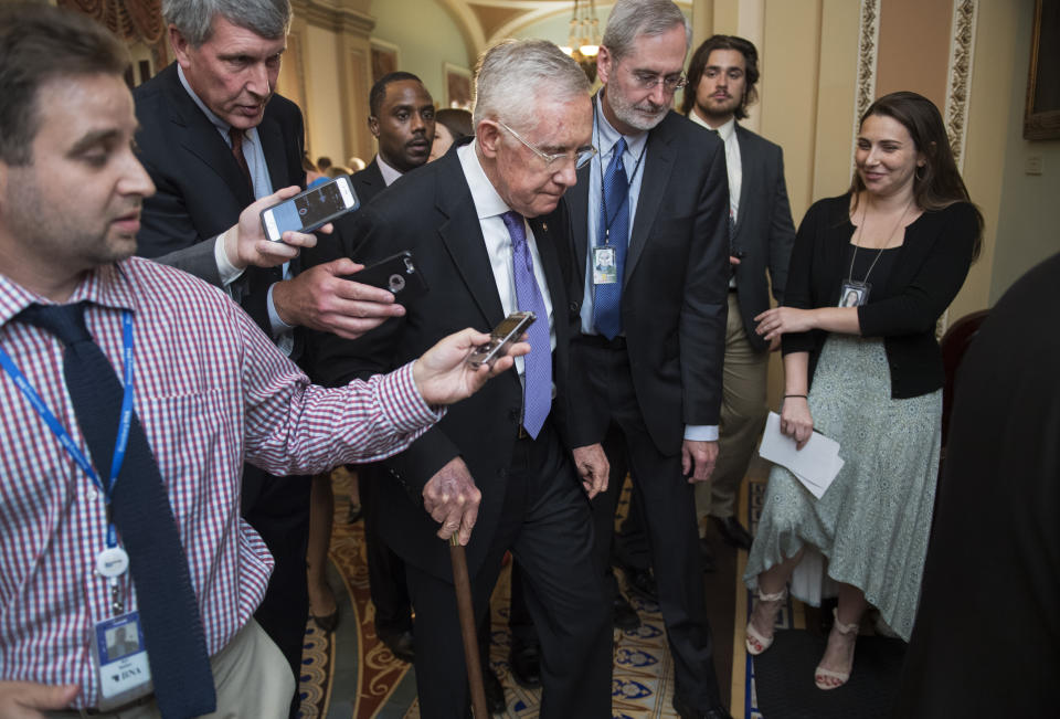 Dauster (center right) was deputy chief of staff to Senate Democratic leader Harry Reid (center) for six years and worked for a number of other senators over the years. (Photo: Tom Williams via Getty Images)