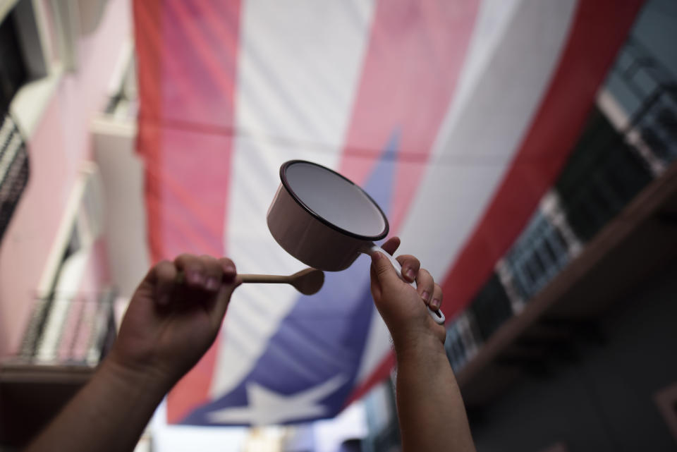 People protest outside the executive mansion known as La Fortaleza, in Old San Juan, demanding the resignation of Governor Wanda Vazquez after the discovery of an old warehouse filled with unused emergency supplies, in San Juan, Puerto Rico, Monday, Jan. 20, 2020. Anger erupted on Saturday after an online blogger posted a live video of the warehouse in the southern coastal city of Ponce filled with water bottles, cots, baby food and other basic supplies that had apparently been sitting there since Hurricane Maria battered the U.S. territory in September 2017. (AP Photo/Carlos Giusti)