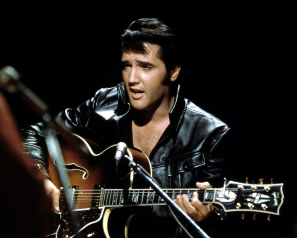 Closeup of Elvis singing an playing aguitar