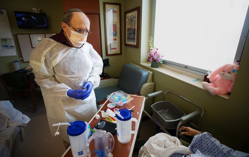 "Yes. I will pray for you," Chaplin Michael Schorin tells a COVID-19 patient who requested spiritual comfort at Gulf Coast Medical Center in Fort Myers, Fla. Schorin says he's been praying a lot lately. "God hasn't forgotten you," Schorin told the patient before leaving.