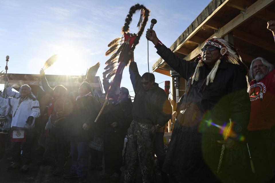 Native Americans lift up their hands to celebrate their victory after&nbsp;the US Army Corps of Engineers&nbsp;shut down the project.