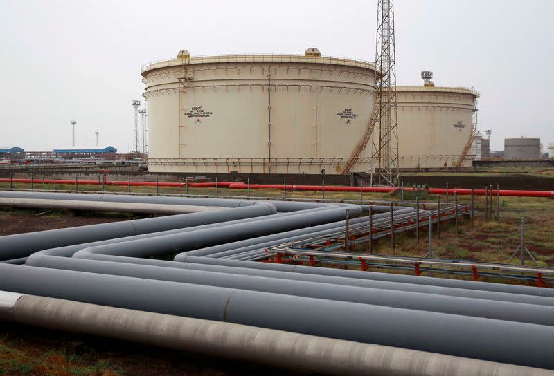 FILE PHOTO: Storage tanks of an oil refinery of Essar Oil are pictured in Vadinar