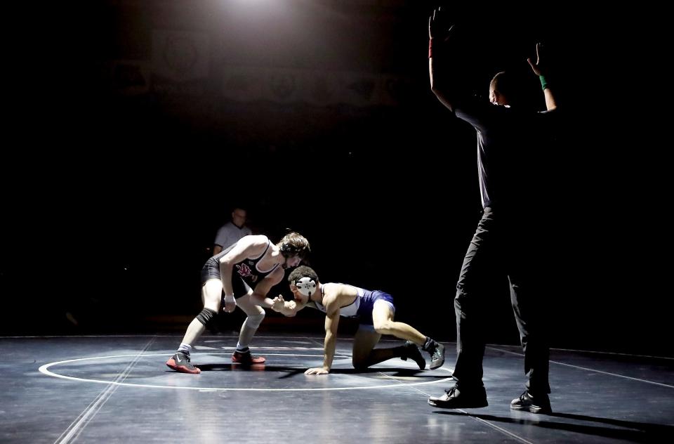 South Kitsap's Stone Hartford, left, wrestles Rogers's Kalai Simeona during their 132-pound bout on Friday, Jan. 20, 2023.