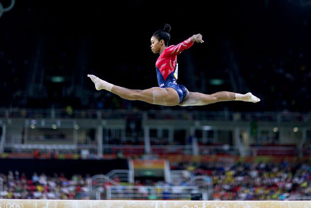 <p>Tim Clayton/Corbis/Getty</p> Gabrielle Douglas performing her routine at the 2016 Rio Olympics.