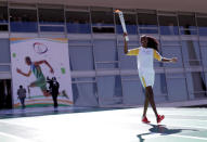 Olympic torch bearer Fabiana Claudino, captain of the Brazilian volleyball team, attends the Olympic Flame torch relay as she leaves the Planalto Palace in Brasilia, Brazil, May 3, 2016. REUTERS/Ueslei Marcelino