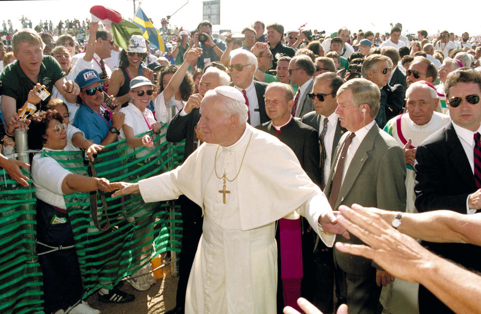 FILE - Pope John Paul II greets participants of World Youth Day as he arrives for Mass at Cherry Creek State Park in Aurora, Colo., Aug. 15, 1993. (AP Photo/Jeff Robbins, File)