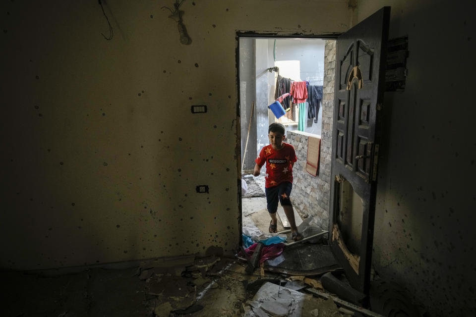 A boy shows enters an apartment after a military raid in the Nur Shams refugee camp near the city of Tulkarem, in the occupied West Bank Saturday, May 6, 2023. Israeli forces shot dead two Palestinians during a military raid in the occupied West Bank Saturday, the Palestinian Health Ministry said, while a local armed group said the pair were militants.The ministry and Tulkarem's branch of Al Aqsa Martyrs Brigades, a militant group with connections to President Mahmoud Abbas' Fatah party, identified the pair as Samer El Shafei and Hamza Kharyoush, both aged 22 years. (AP Photo/Majdi Mohammed)