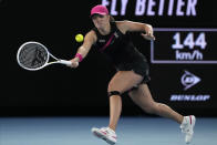 Iga Swiatek of Poland plays a forehand return to Linda Noskova of the Czech Republic during their third round match at the Australian Open tennis championships at Melbourne Park, Melbourne, Australia, Saturday, Jan. 20, 2024. (AP Photo/Andy Wong)
