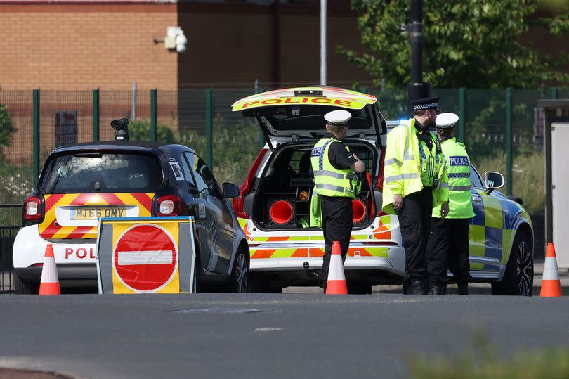 Officers at the scene of a crash involving a police motorbike on Ashton Old Road