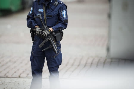 An armed policeman is seen at the Turku Market Square, where several people were stabbed, Turku, Finland August 18, 2017. LEHTIKUVA/Roni Lehti via REUTERS