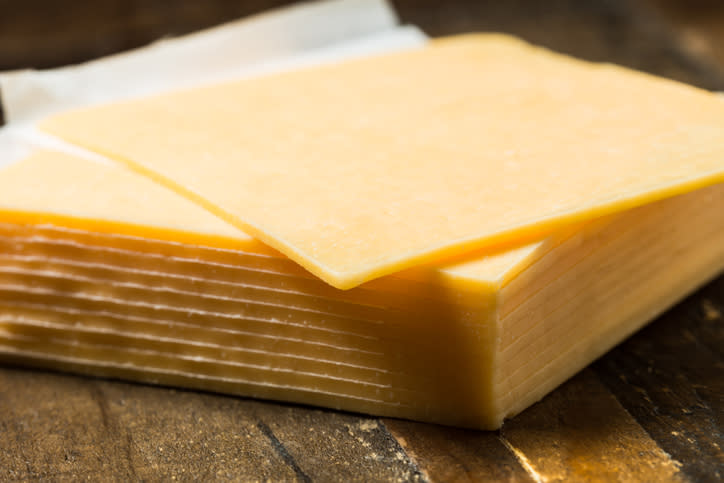 Pictured is sliced cheddar cheese.