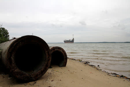Pipes are abandoned on the beach of the Johor river August 24, 2016. REUTERS/Henning Gloystein