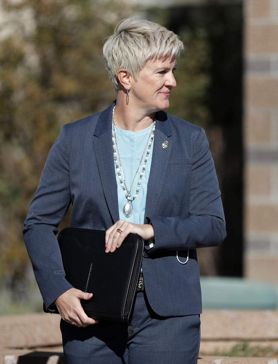 Santa Fe District Attorney Mary Carmack-Altwies looks at her team after a joint news conference with Santa Fe County Sheriff Adan Mendoza in Santa Fe, N.M., Wednesday, Oct. 27, 2021. New Mexico authorities said Wednesday they have recovered a lead projectile believed to have been fired from the gun used in the fatal movie-set shooting. (AP Photo/Andres Leighton)