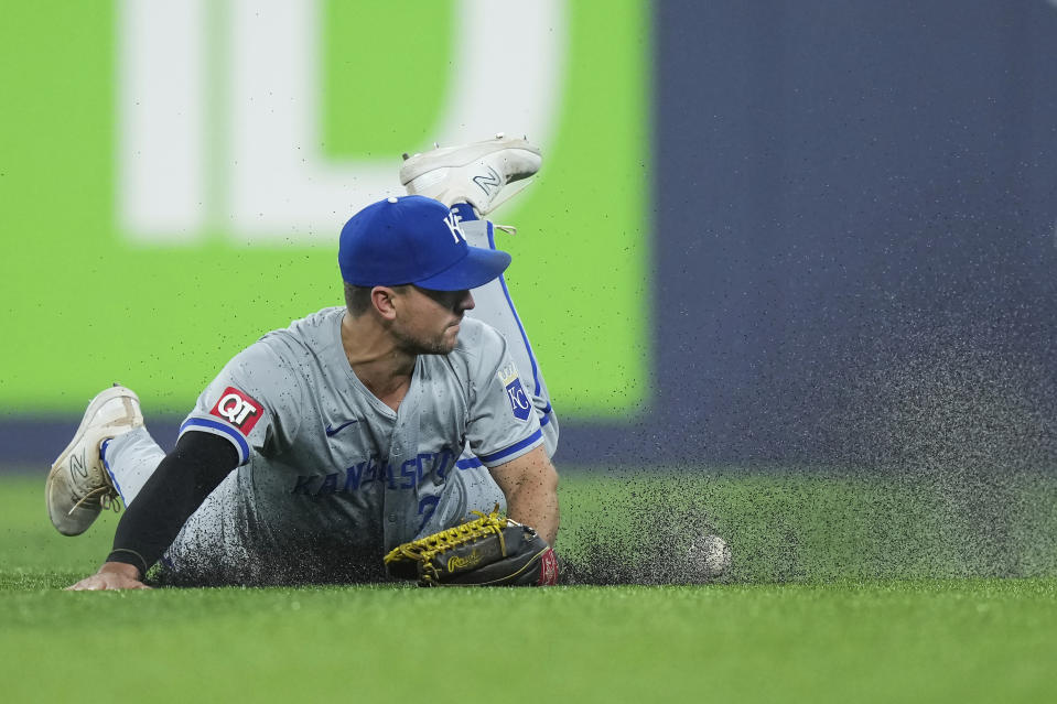 Kansas City Royals outfielder Adam Frazier misses a diving catch on a hit by Toronto Blue Jays' George Springer during eighth-inning baseball game action in Toronto, Monday, April 29, 2024. (Nathan Denette/The Canadian Press via AP)
