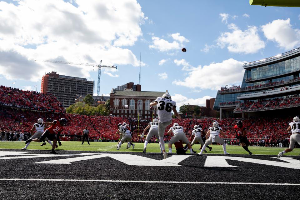 UCF Knights punter Andrew Osteen (36) kicks a punt out of their end zone in the first half of the NCAA football game between the Cincinnati Bearcats and the UCF Knights on Saturday, Oct. 15, 2021, at Nippert Stadium in Cincinnati. 