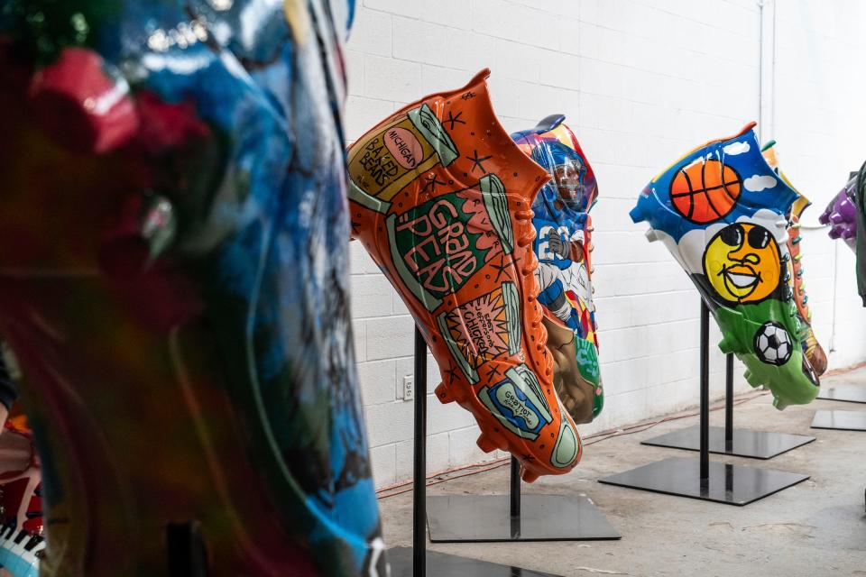 A collection of oversized cleats that were painted with murals by local Detroit artists that are part of the DCLEATED exhibit, which was introduced during a media event at Huber Yard in Detroit on Thursday, March 21, 2024.