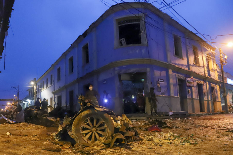 The wreckage of a car bomb that exploded outside City Hall litters the street in Corinto, Colombia, Friday, March 26, 2021. (AP Photo/Juan Bautista Diaz)