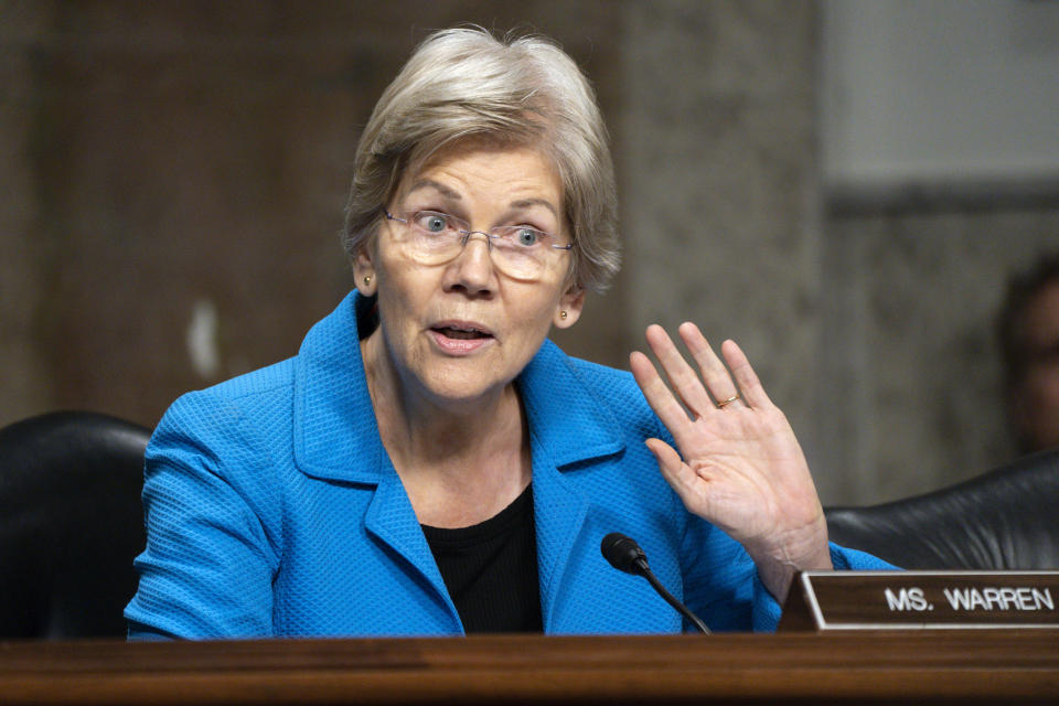 Sen. Elizabeth Warren, D-Mass., holds her hand up to her ear while asking if any of the former bank CEO's plan to repay the FDIC for covering deposits, during a Senate Banking, Housing, and Urban Affairs hearing examining the failures of Silicon Valley Bank and Signature Bank, Tuesday, May 16, 2023, on Capitol Hill in Washington. (AP Photo/Jacquelyn Martin)