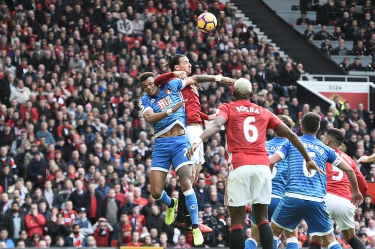 Manchester United's striker Zlatan Ibrahimovic (2L) clashes in the air with Bournemouth's defender Tyrone Mings (L) during the English Premier League football match March 4, 2017