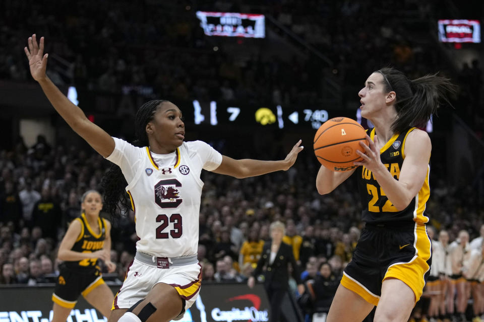 Iowa guard Caitlin Clark (22) shoots over South Carolina guard Bree Hall (23) during the first half of the Final Four college basketball championship game in the women's NCAA Tournament, Sunday, April 7, 2024, in Cleveland. (AP Photo/Carolyn Kaster)