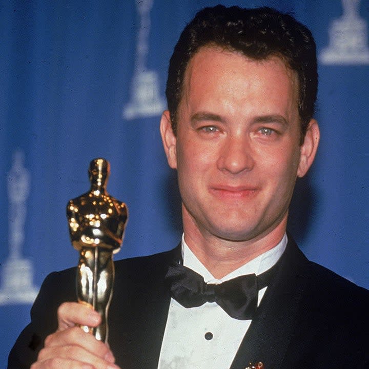 Tom Hanks holds up the Oscar statuette he won for Best Actor for his role in the film 