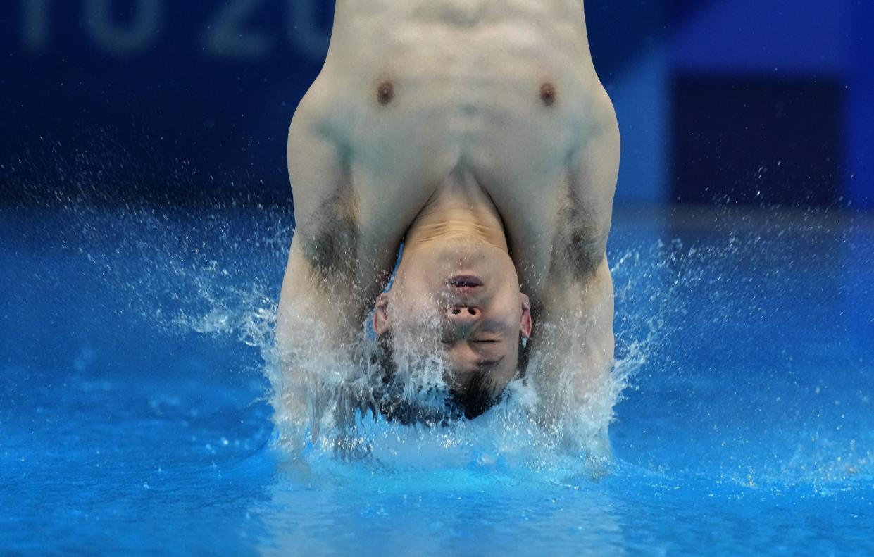 Xie Siyi of China competes in men's diving 3m springboard preliminary at the Tokyo Aquatics Centre at the 2020 Summer Olympics, Monday, Aug. 2, 2021, in Tokyo, Japan.