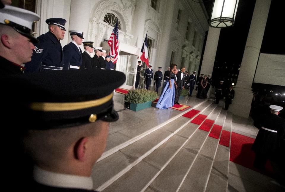 First lady Michelle Obama, left, and President Barack Obama welcome French President François Hollande for a State Dinner at the North Portico of the White House on Tuesday, Feb. 11, 2014, in Washington. (AP Photo/ Pablo Martinez Monsivais)